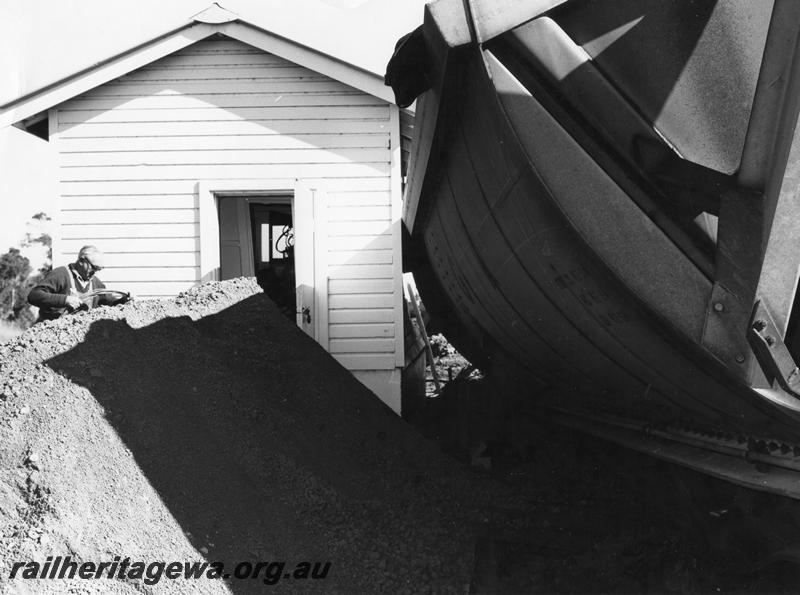 P00447
1 of 4 views of the derailment of a loaded bauxite train at Mundijong, view shows derailed XBC class bauxite hopper resting against a relay cabin, end view.
