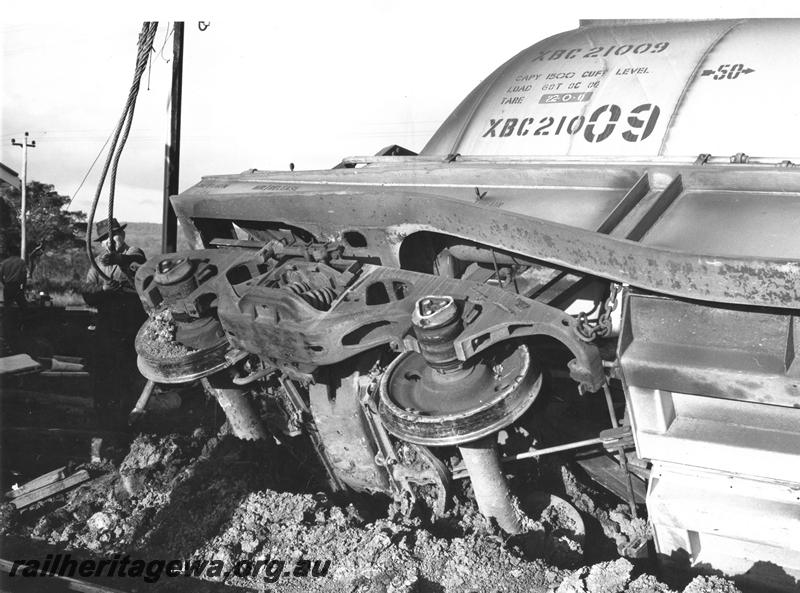 P00449
3 of 4 views of the derailment of a loaded bauxite train at Mundijong, XBC class 21009 bauxite hopper derailed, view of the end of the wagon and the bogie.
