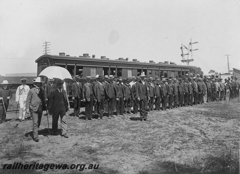 P00520
AA class carriage, men in civilian clothes lined up in ranks in front of the carriage. 
