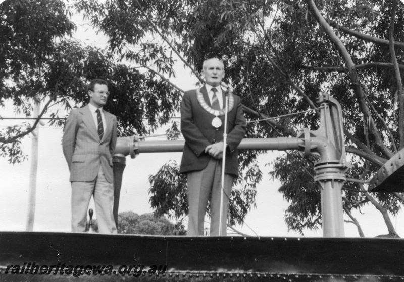 P01794
ARHS president Nicholas Pusenjak with the Mayor of Bassendean, Mr. John Cox standing on the top of the tender of A class 11 celebrating the Centenary of A 11's entry into service with the WAGR (see 