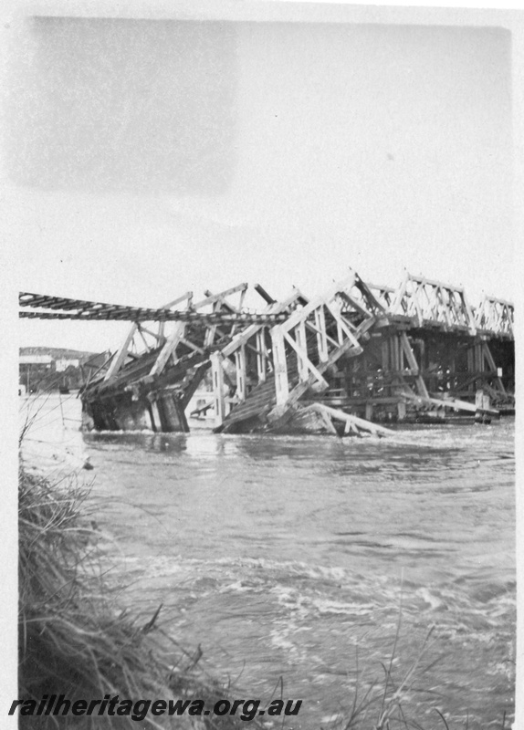 P01803
Fremantle Railway Bridge collapse which occurred on the afternoon of the 22nd of July, 1926,  North Fremantle, due to the 1926 flood, shows rails suspended and the collapsed trusses.
