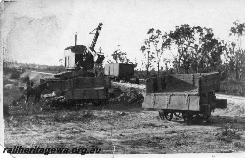 P02014
12 of 14. Ruston steam shovel, on embankment, 4 wheeled side tipping wagons, one wagon with side down showing interior of wagon, several wagons derailed, draught horse, side and front view, construction of Denmark-Nornalup railway, D line.
