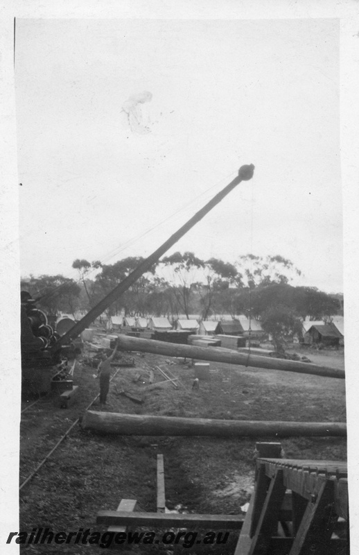 P02061
Steam crane, bridge construction, lifting a pile, workers camp in the background, possibly Guildford
