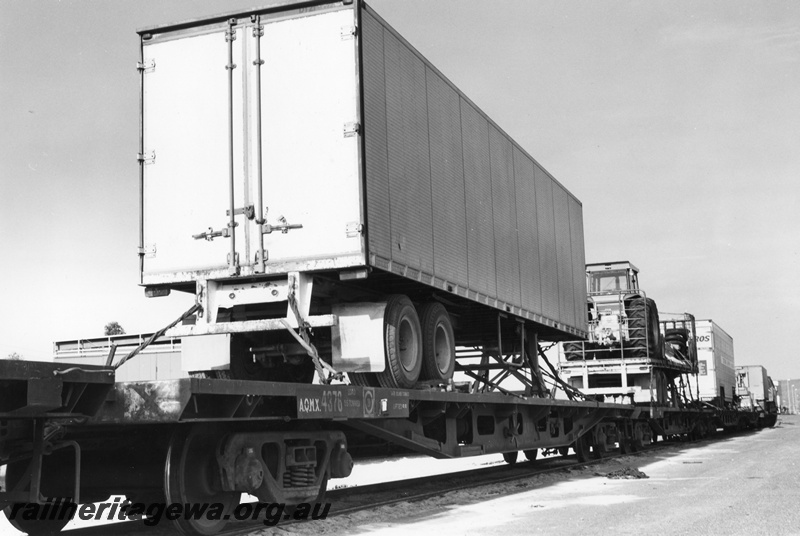 P02079
Semi trailer loaded onto a standard gauge flat wagon, Kewdale Piggy Back Area, view of the rear of the trailer
