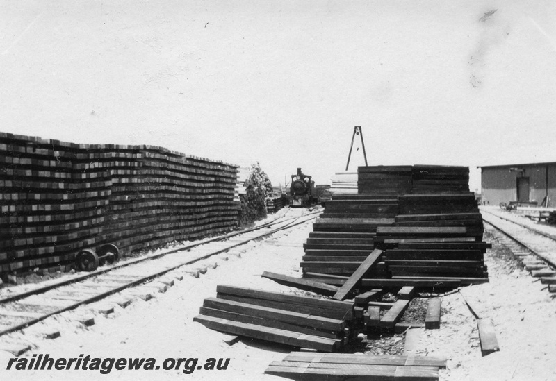 P02082
3 of 44 views of the construction of the railway at Esperance, CE line taken by Cedric Stewart, the resident WAGR engineer, stockpiles of sleepers, G class 156 loco in the background
