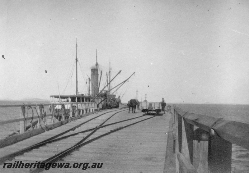 P02146
36 of 44 views of the construction of the railway at Esperance, CE line taken by Cedric Stewart, the resident WAGR engineer, Esperance jetty with ship tied up and horse and wagons on jetty.
