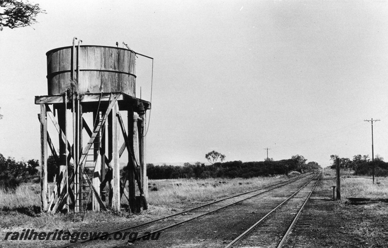 P02310
Water tower with a cylindrical tank, location Unknown but possibly Muchea, MR line, end and trackside view.
