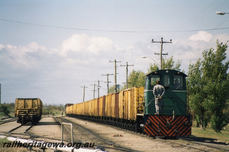 P02575
SEC Comeng 0-6-0 loco coupled to a rake of 12 GH class wagons. An unidentified A class loco  atached at the far end,  SECWA Bunbury.
