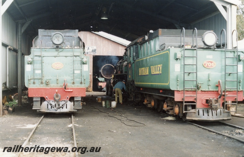 P02959
W class 908 and PM class 706 steam locomotives in the HVR loco shed, view of their tenders, view of W class 903's boiler tubes in the background, Pinjarra.
