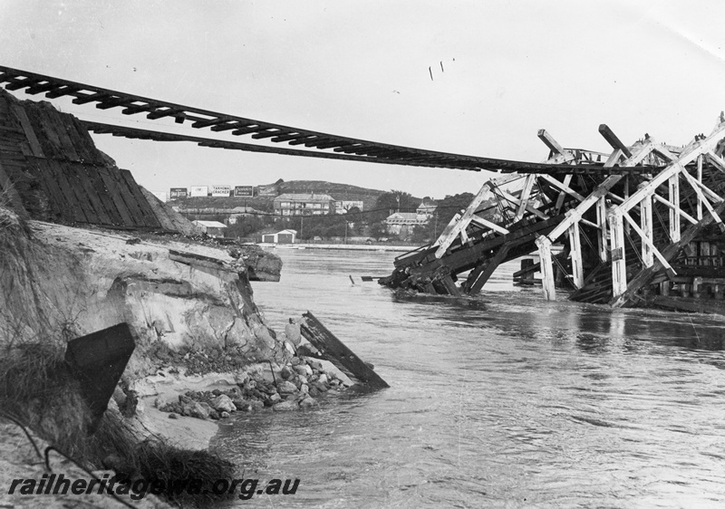 P02995
Fremantle Railway Bridge collapse which occurred on the afternoon of the 22nd of July, 1926, view looking up river with the rails suspended in mid air, see also P01802, P05185, P07085, P07086, North Fremantle, ER line.

