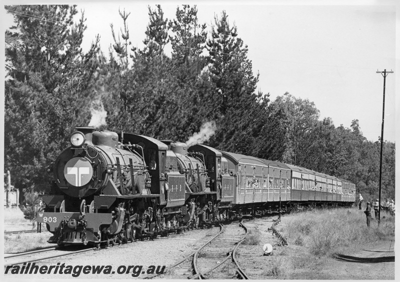 P03260
W class 903 double heading with W class 945 steam locomotives, lead loco a Telecom logo on the smoke box cover, arriving at Dwellingup on a HVR train, cheese knob, catch points, tall telegraph pole.
