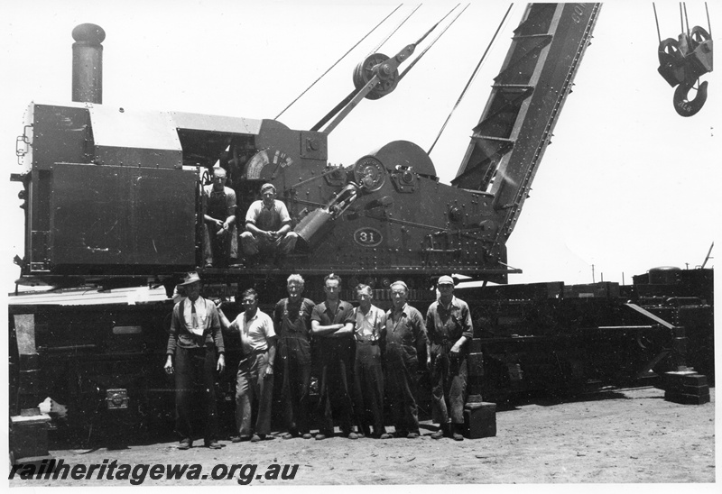 P03578
2 of 7 images of the Cowans Sheldon 60 ton breakdown crane No.31, view of cab and cylinder, workers standing in front of the crane
