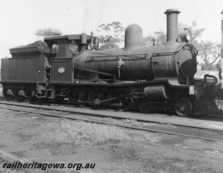 P03596
G class 118, 4-6-0. Yard shunting loco at East Perth Loco Sheds, Next to Unknown railcar. Side view
