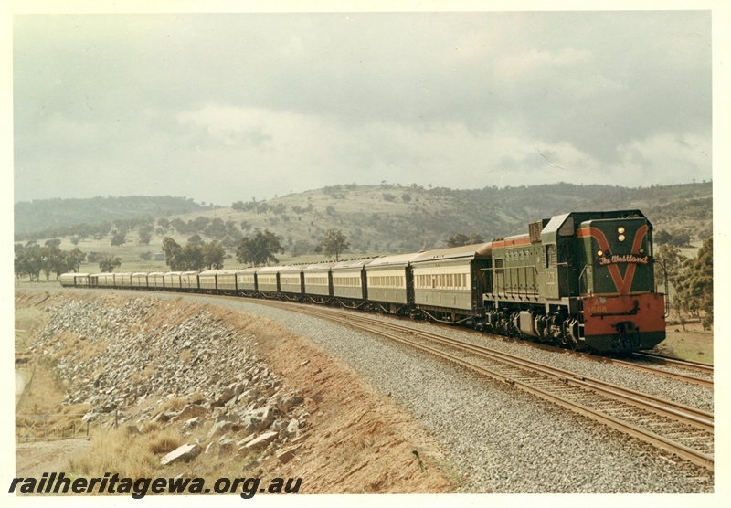 P03963
A class 1508 diesel locomotive in green with red and yellow stripe livery hauling 