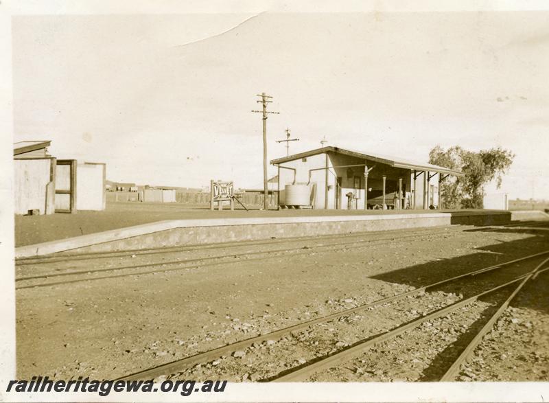 P06307
Station buildings, mens toilet, station building  with platform scales, Out of Shed, stone faced platform,  sign advertising 