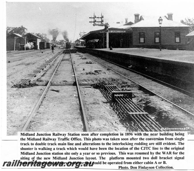 P06724
Station buildings, signal, goods shed, Midland Junction, trackside view looking west
