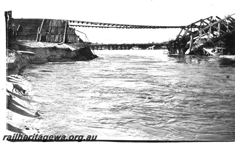 P07085
Fremantle Railway Bridge collapse which occurred on the afternoon of the 22nd of July, 1926, view looking up river with the rails suspended in mid air, see also P01802, P05185, P07086, North Fremantle, ER line.
