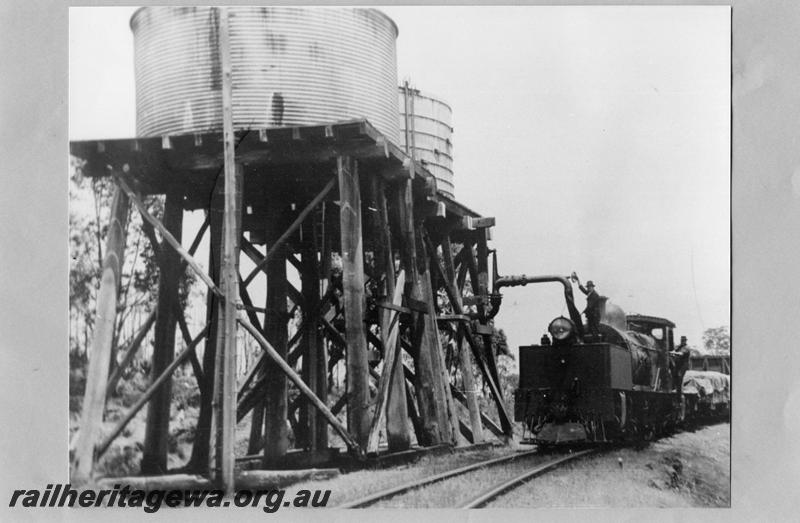 P07589
M class 391 Garratt on No. 191 Mixed Goods, water towers with a corrugated iron tank and a wooden tank, , Bergining, PN line, taking water.view along the track
