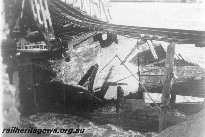 P08052
Fremantle Railway Bridge collapse which occurred on the afternoon of the 22nd of July, 1926, view along the side of the bridge showing the trusses collapsed into the river, See also P07086, P21471,P08051, P21471, ER line.
