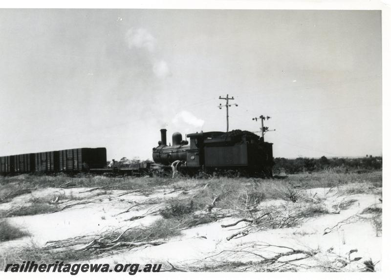 P08108
3 of 3 views of G class 233 struggling with a long rake of GH class coal wagons between the Bunbury Power House and the old Bunbury Station on the original rail connection, fireman is scooping up sand and placing it on the rails.
