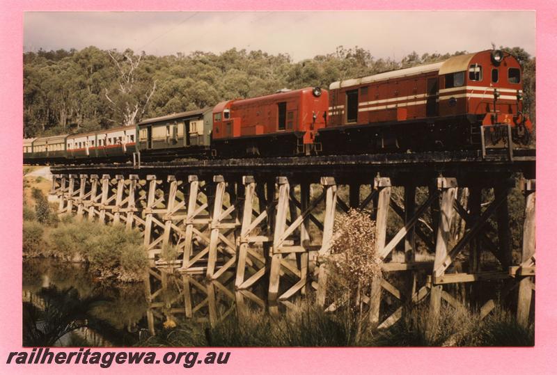 P08130
F class 43, MRWA livery, double heading with F class 45, plain red livery,crossing the trestle bridge over the Hotham River at Tullis, ARHS tour train returning from Boddington, PN line, view along the train, see also P00668
