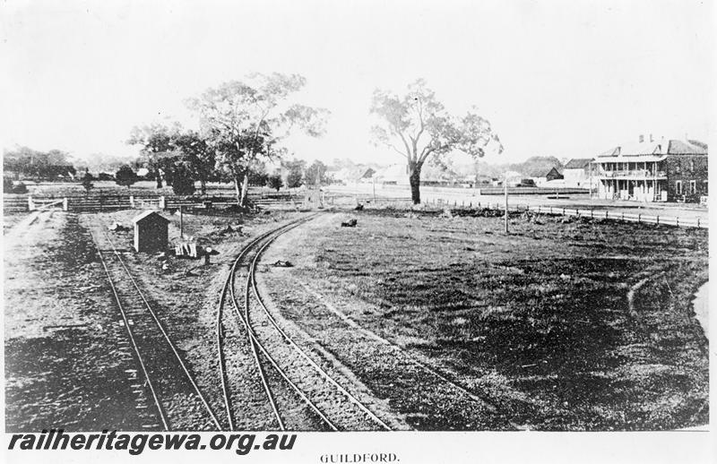 P09551
Original terminus of the Eastern Railway at Guildford, view shows the extension to Chidlow's Well curving away to the right to travel along Ellen street, now Johnson Street. Guildford Hotel seen in background
