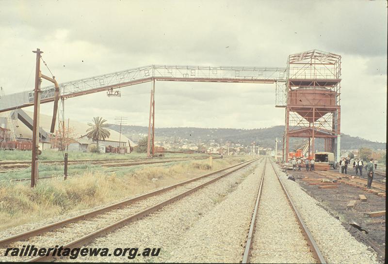 P09833
Grain transfer facility, under construction, grain silo, narrow gauge main lines, signals, Midland Junction marshalling yards. ER line.
