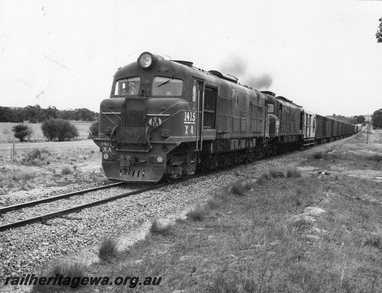 P10404
XA class1415 and XB class1004 hauling a rake of bogie livestock wagons. Unidentified rollingstock at rear of train.
