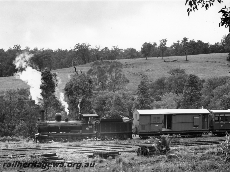 P10442
G class 233 steam locomotive and Z class 492 brakevan at head of the Vintage Train at Beela. BB line.. This was a hired passenger special from Bunbury Jetty to Beela and return for crew of Leander-class frigate HMS Scylla of the Royal Navy. 
The train consisted of three ACM Class suburban dogbox carriages sandwiched between two Z Class brakevans. 
