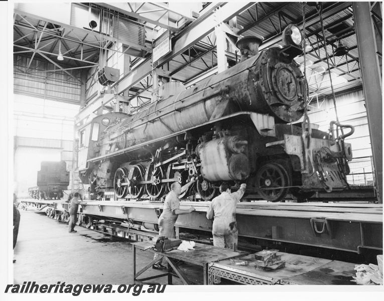 P10510
W class 901 steam locomotive being loaded onto a Commonwealth Railway QB class flat top prior to departing to South Australia. At the rear is the tender of the locomotive on a similar wagon.
