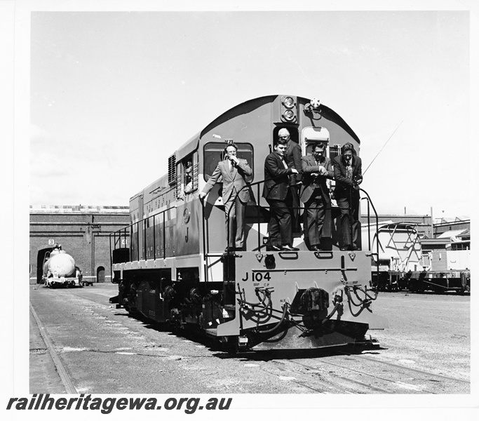 P10552
Mechanical Staff personnel on the front running board of standard gauge diesel locomotive J class 104 after overhaul at Midland Workshops. See also P13713 and P13714. 
