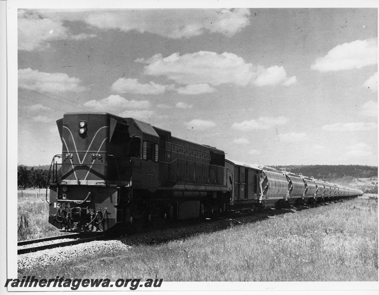 P10611
 D class 1564 diesel locomotive hauling a rake of alumina wagons towards Pinjarra from the Alcoa Refinery.

