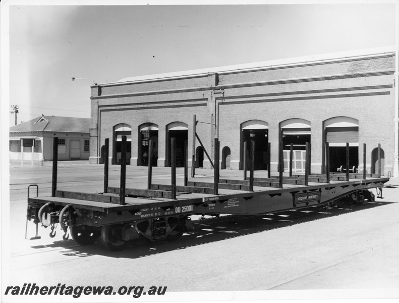 P10614
QU class 25001 narrow gauge flat top wagon, fitted with bolsters and stanchions, after overhaul. Note the clean outside area of the Workshops. Same as P10969
