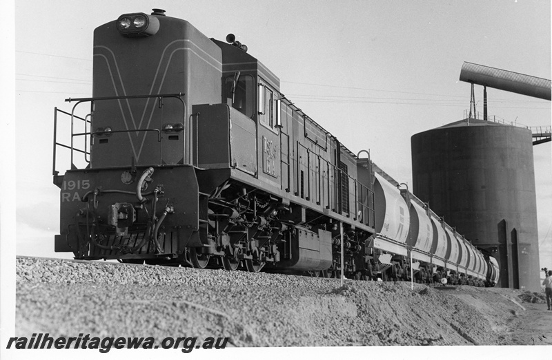 P10698
RA class narrow gauge diesel locomotive at the head of a mineral sands train being loaded at Eneabba. DE line
