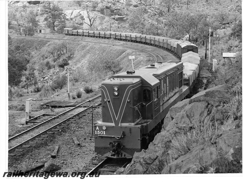 P10699
A class 1501 narrow gauge diesel locomotive hauling a loaded grain train after exiting the Swan View Tunnel enroute to Midland.
