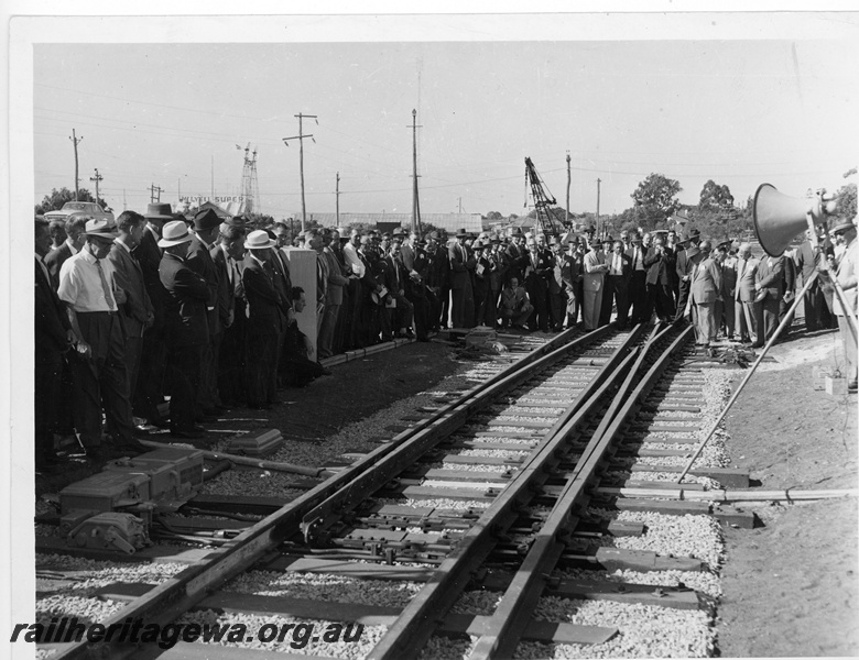 P10939
A gathering of interested guests and railway personnel gather around a dual gauge set of points which incorporate a moveable set of 'baby K' points.
