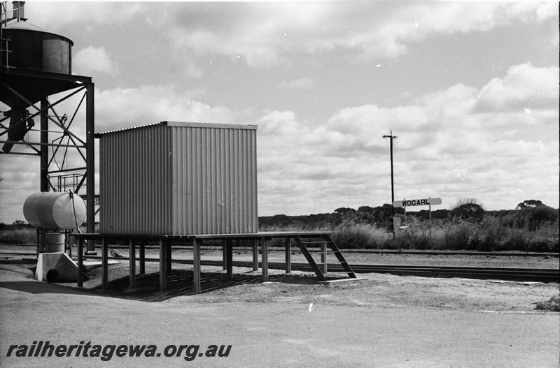 P11106
Station shed on platform, nameboard, grain loader, Wogarl, NKM line, view of rear of shed.
