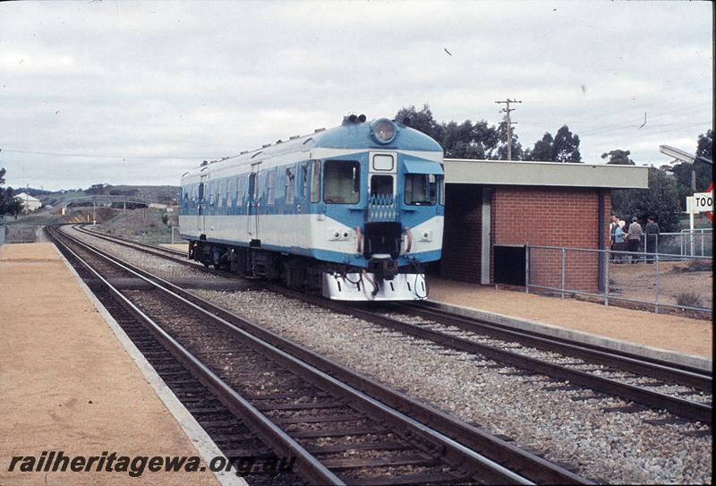 P11478
ADX class 670,  Nanking  blue and light grey livery, stainless steel cowcatcher side and front view, station building, low level platforms,  Toodyay , Avon Valley line, ARHS tour to Northam.
