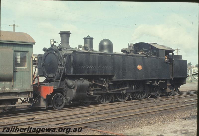 P11593
DD class 597 with non bifurcated spokes, front and side view, coupled to a Z class brakevan in the green livery with a grey roof, shunting East Perth yard. ER line.
