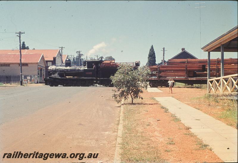 P11808
State Saw Mills loco SSM 7, QC class 23501  loaded with sawn timber, crossing SW Highway on way to Pemberton station. Side on view looking up the street, PP line
