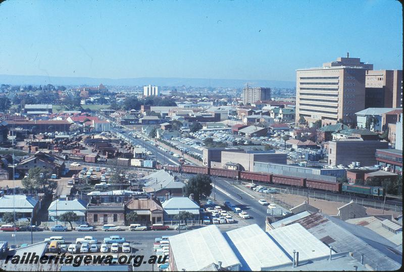 P12247
Moore St crossing, Perth, with R class on up goods, from top of Canterbury Court. ER line.
