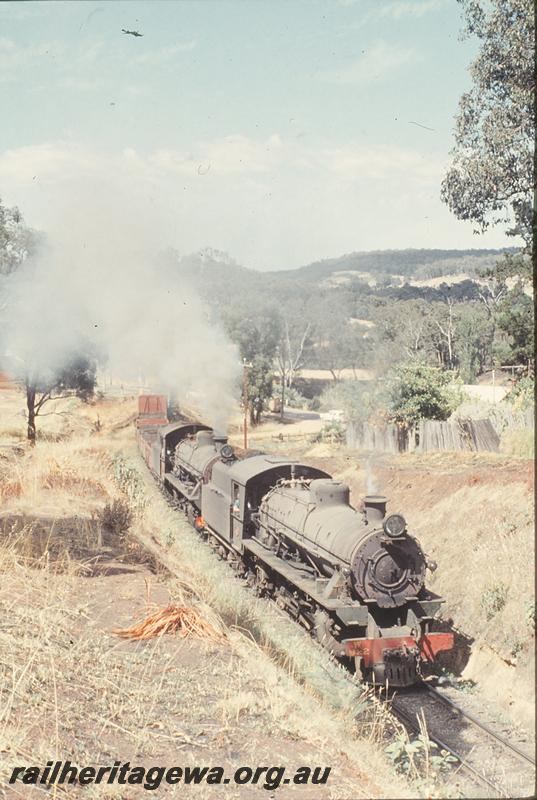 P12427
W class 922, W class 924, level crossing, 2nd ballast train climbing bank from river bridge into Bridgetown, PP line. Additional wagons for brake power.
