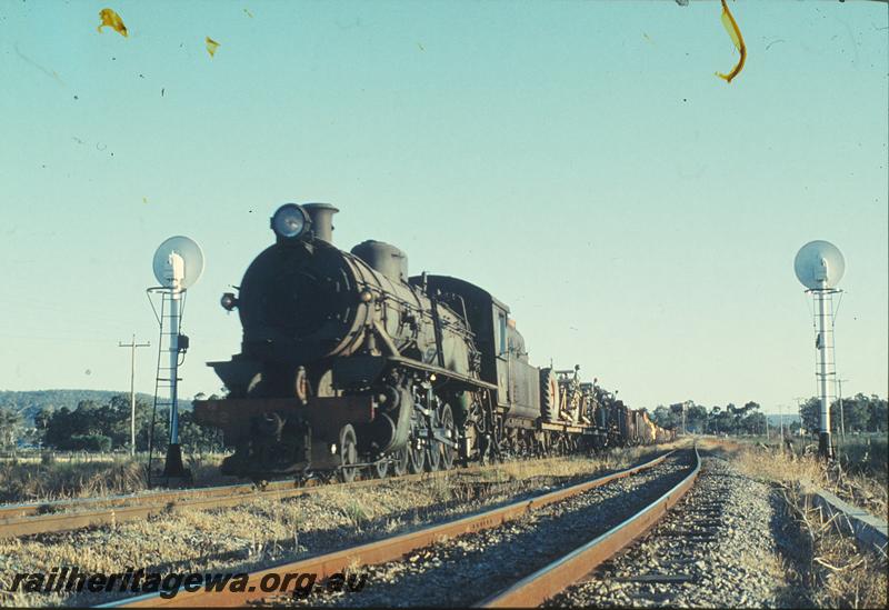 P12446
W class 942, up goods, colour light signals, water tower in background, north end of Serpentine, SWR line. Agricultural machinery on leading wagons.
