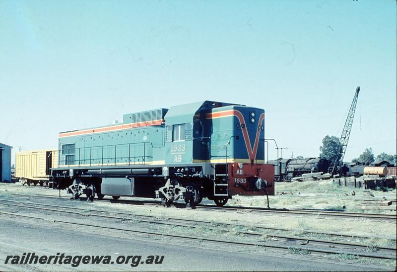 P12460
AB class 1533, on SG transfer bogies, Midland Workshops sidings. SG van, V class, DD class in background.
