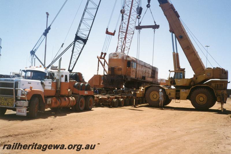 P12535
Port Hedland Nelson Point yard, Goldsworthy Mining A class English Electric No.5 being loaded onto a Bell road float for transporting to Perth

