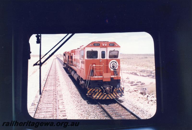 P12545
Coon Siding, 175 km on the Port Hedland - Newman railway, Mount Newman Mining locos Goninan rebuild CM36-7M class 5511 on the mainline light engine, view from cab window, BHP line

