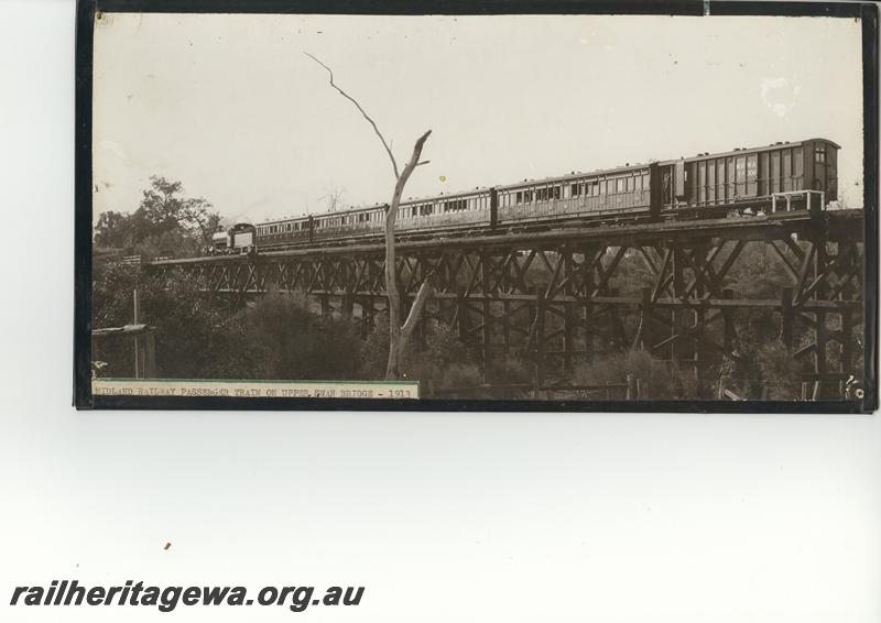 P12554
MRWA FA class 306 brakevan on passenger train hauled by a C class loco on the trestle bridge at Middle Swan, MR line, opposite side view of train to P12553 . (scanned print located in MC1B2G)
