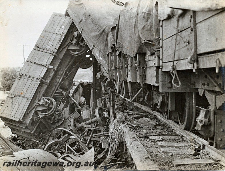 P12925
4 of 8 images of a derailment at Dumberning, BN line, derailed wagons including GA class 6070 suspended almost vertically off the track. Date of derailment 14/3/1934
