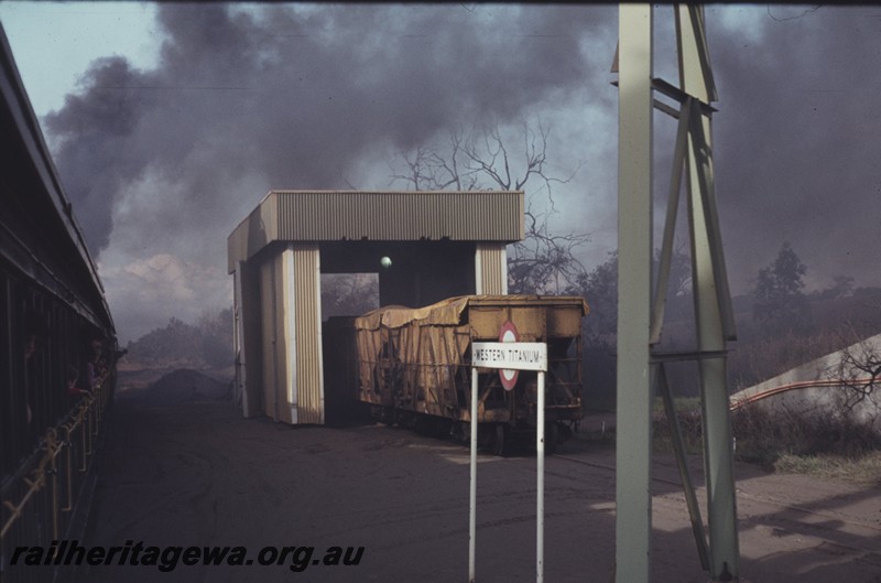 P12973
XAC Class coal hoppers, station nameboard, Western Titanium, BB line, hoppers being unloaded, view from passing train
