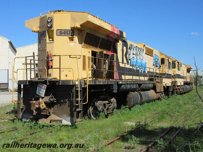 P13474
Ex Robe River M636 class 9417, on transfer bogies, on the track leading to the UGL plant, Bassendean, long hood end and side view, awaiting a decision on its fate.
